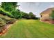 Lush backyard provides privacy with mature trees, an inviting lawn, and a peaceful outdoor oasis at 2726 Riderwood Ne Ln, Marietta, GA 30062