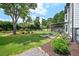 Manicured back yard with garden and mature trees at 3065 Foxhall Overlook, Roswell, GA 30075