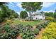 Sprawling landscaped back yard with flowering bushes at 3065 Foxhall Overlook, Roswell, GA 30075
