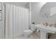 Bright bathroom with a white pedestal sink and shower with white curtain at 3065 Foxhall Overlook, Roswell, GA 30075