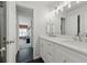 Modern bathroom featuring double sinks, marble countertops, and an open view to the living area at 3065 Foxhall Overlook, Roswell, GA 30075