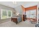 Bedroom with natural lighting, comfortable bed, desk, and a cozy rocking chair at 3065 Foxhall Overlook, Roswell, GA 30075