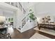 Stunning entryway showcasing modern staircase, dark wood floors, and ample natural light at 3065 Foxhall Overlook, Roswell, GA 30075