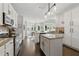 Well-lit kitchen with granite counters, stainless appliances, and a view into the dining area and backyard at 3065 Foxhall Overlook, Roswell, GA 30075