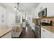 Bright kitchen boasts stainless appliances, granite countertops, and a functional island with bar seating at 3065 Foxhall Overlook, Roswell, GA 30075