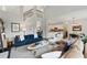 Open-concept living room with modern decor, fireplace, staircase, and view to kitchen at 3065 Foxhall Overlook, Roswell, GA 30075