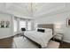 This main bedroom features a tray ceiling, hardwood floors, and a sitting area by a bank of windows at 3065 Foxhall Overlook, Roswell, GA 30075