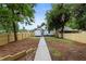 Spacious backyard featuring a new fence, and a sidewalk leading to the two-story home at 1283 Beecher Sw St, Atlanta, GA 30310