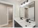 Contemporary bathroom with a double vanity, modern lighting, and neutral wall colors at 1283 Beecher Sw St, Atlanta, GA 30310