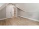 Bright bedroom with wood flooring, white trim, and a view into another room at 1283 Beecher Sw St, Atlanta, GA 30310