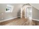 Cozy bedroom featuring sloped ceilings, wood floors, and a walk-in closet at 1283 Beecher Sw St, Atlanta, GA 30310