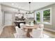 Dining area with table, chairs, and open access to the modern kitchen at 1283 Beecher Sw St, Atlanta, GA 30310