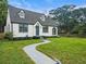 Charming home showcasing a blue front door, dormer windows, gray roof, and a curved sidewalk at 1283 Beecher Sw St, Atlanta, GA 30310