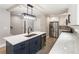 Modern kitchen featuring an island, stainless steel appliances, white cabinets, and stylish lighting at 1283 Beecher Sw St, Atlanta, GA 30310