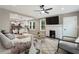 Open-concept living room featuring fireplace, ceiling fan, and a seamless flow to the kitchen and dining area at 1283 Beecher Sw St, Atlanta, GA 30310