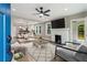 Cozy living room with a fireplace, area rug, ceiling fan, and an open layout to the kitchen and dining area at 1283 Beecher Sw St, Atlanta, GA 30310