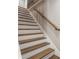 Elegant staircase with hardwood treads, white risers, and a wooden handrail at 1283 Beecher Sw St, Atlanta, GA 30310