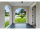 Sunroom with arched windows offering a view of the lawn and street, providing natural light at 1283 Beecher Sw St, Atlanta, GA 30310