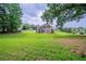 Large grassy backyard view of the two-story house from the back at 157 Hambrick Dr, Stockbridge, GA 30281