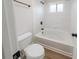 Clean bathroom with a tub and shower combo, window, and tile surround at 157 Hambrick Dr, Stockbridge, GA 30281