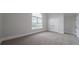 Well-lit bedroom with soft carpet, large arched window, and ample closet space at 157 Hambrick Dr, Stockbridge, GA 30281