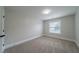 Cozy bedroom with neutral walls, soft carpet, and natural light from the window at 157 Hambrick Dr, Stockbridge, GA 30281
