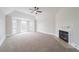 Bright bedroom with a vaulted ceiling, ceiling fan, fireplace, carpeted floors and a bay window at 157 Hambrick Dr, Stockbridge, GA 30281