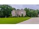 Charming two-story brick home with a well-manicured lawn and mature trees at 157 Hambrick Dr, Stockbridge, GA 30281