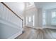 Bright foyer with wood floors, staircase and a modern front door at 157 Hambrick Dr, Stockbridge, GA 30281