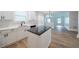 Contemporary kitchen with a center island, white cabinets and modern fixtures at 157 Hambrick Dr, Stockbridge, GA 30281