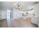 Open-concept kitchen with white cabinets, a center island and modern lighting at 157 Hambrick Dr, Stockbridge, GA 30281