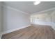 Spacious living room with light wood floors, crown molding, wainscoting, and large windows for natural light at 157 Hambrick Dr, Stockbridge, GA 30281