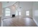 Spacious living room with vaulted ceilings, large windows, a fan and a fireplace at 157 Hambrick Dr, Stockbridge, GA 30281