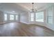 Bright living room featuring light wood floors, crown molding, and a wall of windows offering ample natural light at 157 Hambrick Dr, Stockbridge, GA 30281