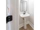 Chic powder room with pedestal sink, modern fixtures, and neutral decor at 157 Hambrick Dr, Stockbridge, GA 30281