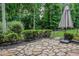 Picturesque backyard with mature trees, lush shrubbery, and patio at 2630 Timler Trce, Snellville, GA 30078