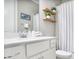 Stylish bathroom featuring a white vanity, elegant mirror and shower at 2630 Timler Trce, Snellville, GA 30078