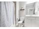 Functional bathroom showcasing a combined shower and tub, vanity, and a decorative mirror at 2630 Timler Trce, Snellville, GA 30078