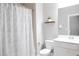 Clean bathroom featuring a shower with a patterned curtain, toilet, and vanity with mirror at 2630 Timler Trce, Snellville, GA 30078