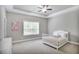 Serene bedroom featuring a crib, neutral tones, and ample natural light for a calm, inviting atmosphere at 2630 Timler Trce, Snellville, GA 30078