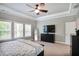 Bright bedroom with large windows, ceiling fan, and a full-length mirror adding depth to the space at 2630 Timler Trce, Snellville, GA 30078