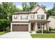 Charming two-story home featuring a brick facade, covered porch, and a two-car garage at 2630 Timler Trce, Snellville, GA 30078