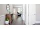 Elegant hallway featuring dark wood floors, a decorative table, and neutral wall paint at 2630 Timler Trce, Snellville, GA 30078