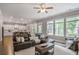 Open living area featuring hardwood floors, large windows, and a comfortable sectional sofa at 2630 Timler Trce, Snellville, GA 30078