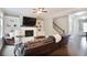Cozy living room with a fireplace, built-in shelves, and comfortable leather furniture at 2630 Timler Trce, Snellville, GA 30078