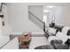Comfortable living room with a sectional sofa, accent pillows, and dark hardwood floors leading to the staircase at 2630 Timler Trce, Snellville, GA 30078