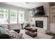 Spacious living room with cozy seating arrangement, fireplace, and large TV for entertaining guests at 2630 Timler Trce, Snellville, GA 30078