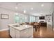 Open-concept living space that connects a modern island kitchen and living room at 2630 Timler Trce, Snellville, GA 30078