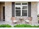 Inviting front porch features wicker chairs and a small table, creating a cozy outdoor seating area at 2630 Timler Trce, Snellville, GA 30078