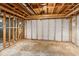Unfinished basement featuring concrete flooring, exposed ceiling and wooden framing ready to be transformed at 3267 Remembrance Trce, Lawrenceville, GA 30044